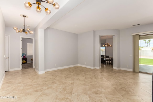 unfurnished living room featuring a chandelier and light tile patterned floors