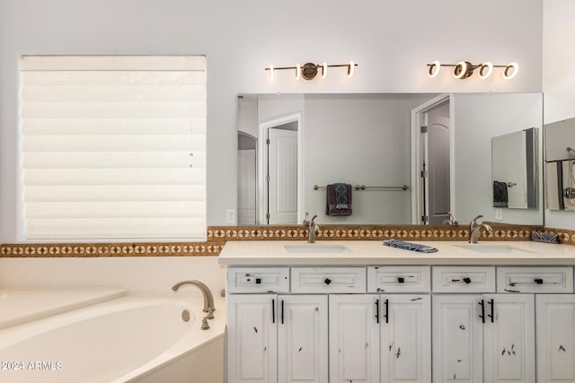 bathroom with dual vanity and a tub to relax in