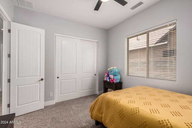 carpeted bedroom with a closet and ceiling fan