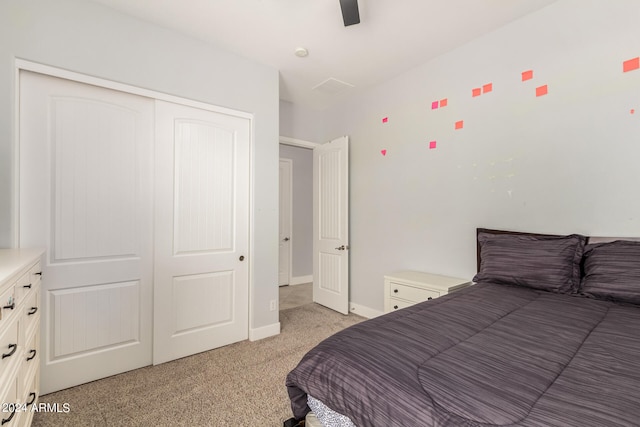 carpeted bedroom with a closet and ceiling fan