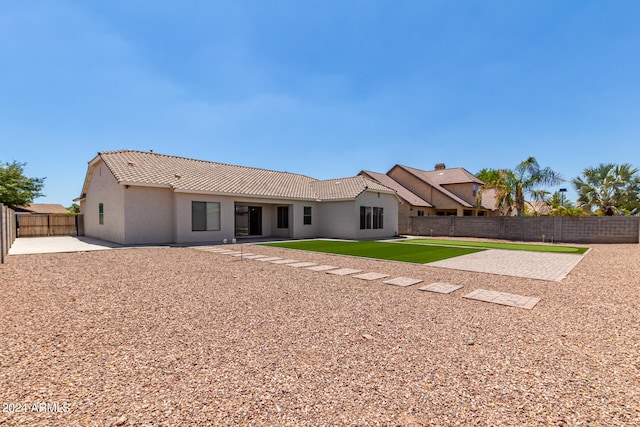 back of property with a patio