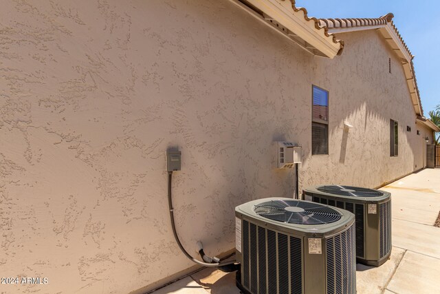 view of side of home featuring central air condition unit and a patio area