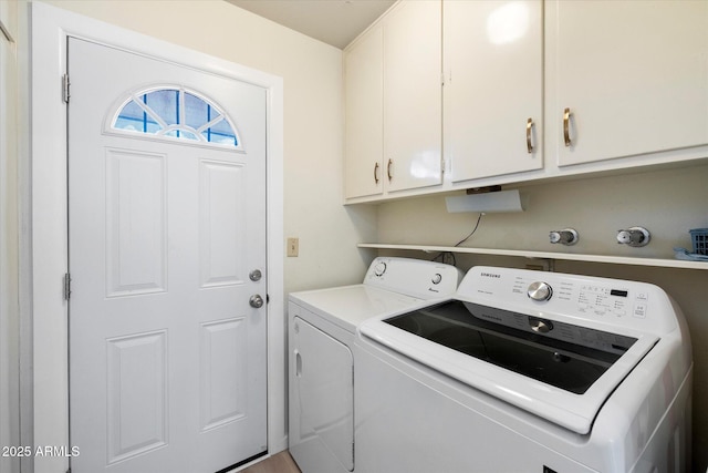 clothes washing area with cabinet space and washer and clothes dryer