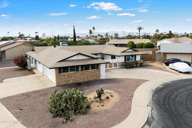 ranch-style house featuring a residential view, brick siding, concrete driveway, and an attached garage