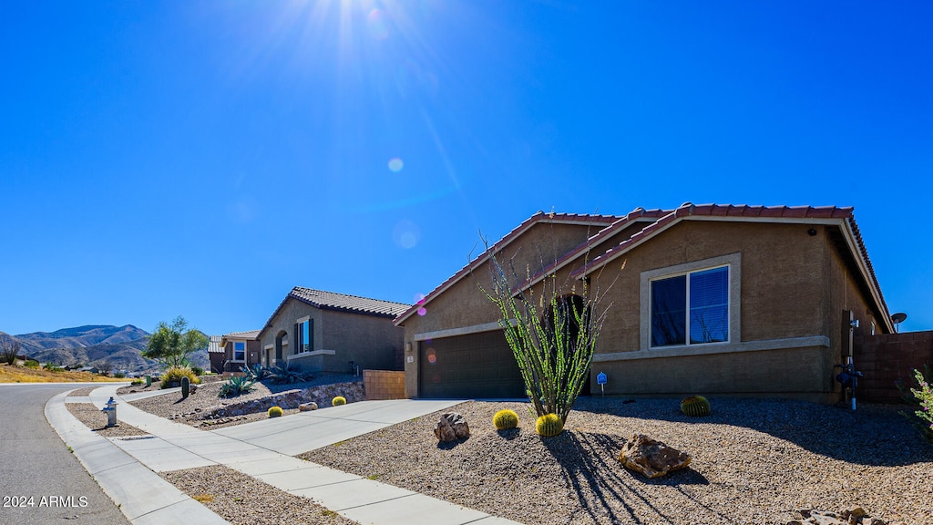 view of front of property featuring a mountain view and a garage