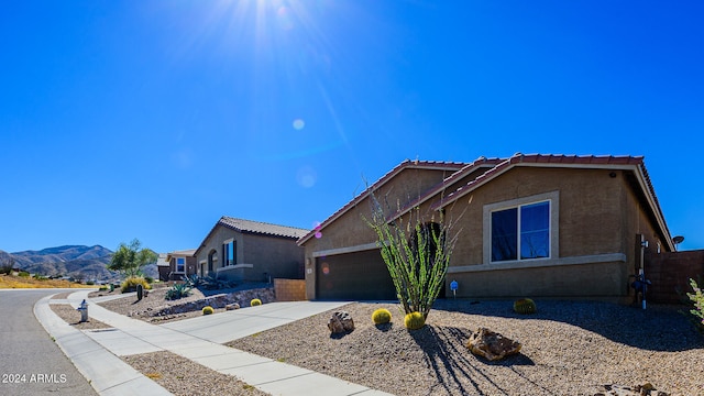 view of front of property featuring a mountain view and a garage