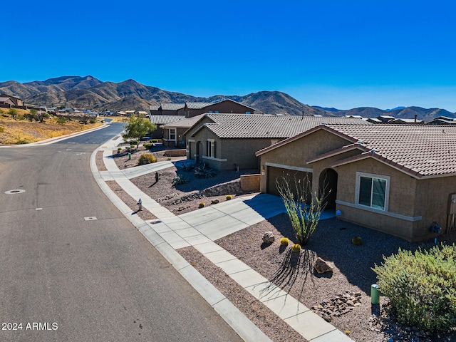 view of front facade with a garage and a mountain view