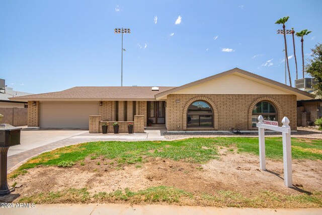 ranch-style home featuring a garage