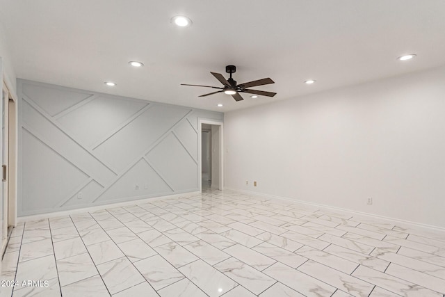 unfurnished room with baseboards, marble finish floor, a ceiling fan, and recessed lighting