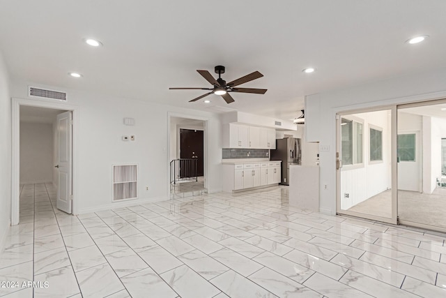 unfurnished living room with ceiling fan, marble finish floor, visible vents, and recessed lighting