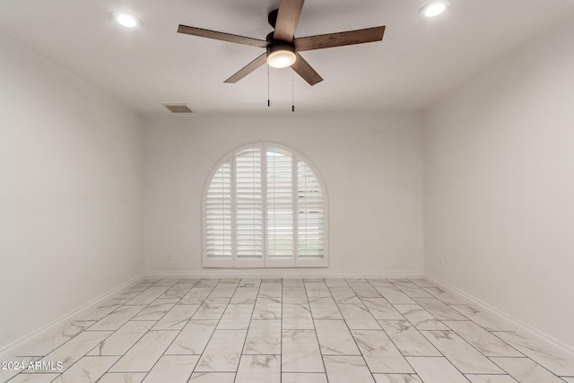 unfurnished room with ceiling fan, marble finish floor, visible vents, and recessed lighting