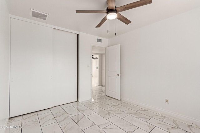 unfurnished bedroom featuring a ceiling fan, baseboards, visible vents, and a closet