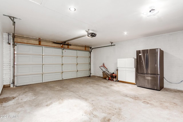 garage with a garage door opener and freestanding refrigerator