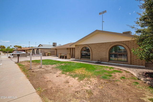 view of front of home with brick siding and a patio area