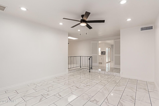 empty room with baseboards, visible vents, a ceiling fan, marble finish floor, and recessed lighting