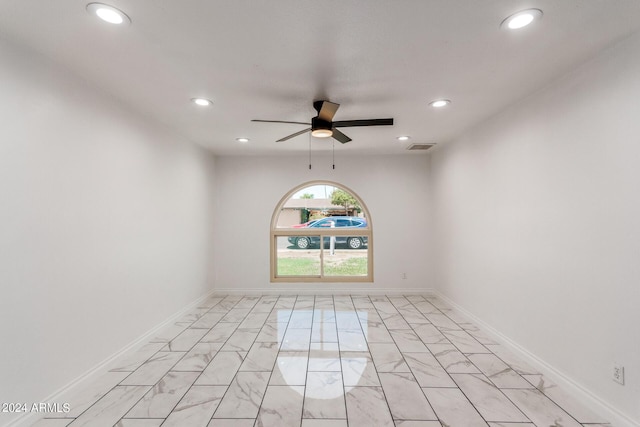 spare room featuring baseboards, marble finish floor, and recessed lighting