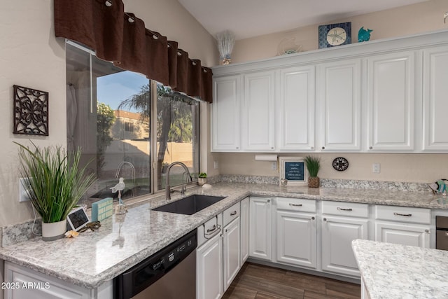 kitchen featuring dark wood-style flooring, dishwasher, a sink, light stone counters, and white cabinetry