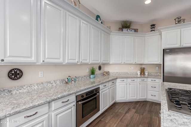 kitchen with dark wood finished floors, white cabinets, and stainless steel appliances