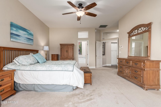 bedroom with light colored carpet, ceiling fan, visible vents, and baseboards
