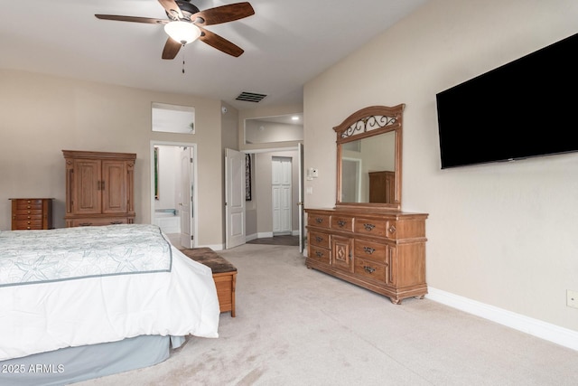 bedroom with visible vents, light carpet, baseboards, a ceiling fan, and ensuite bath