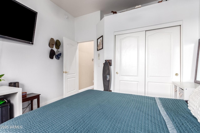 bedroom with baseboards and a closet