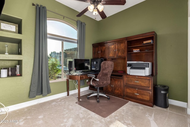 office area featuring baseboards, light carpet, and a ceiling fan