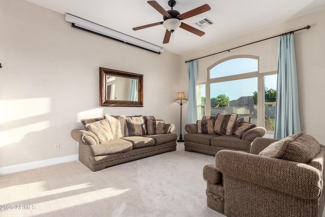 carpeted living area featuring baseboards, a ceiling fan, and visible vents