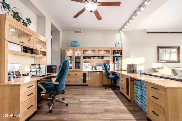 office area featuring visible vents, wine cooler, ceiling fan, built in desk, and light wood finished floors