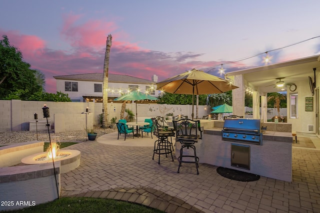 view of patio / terrace with a fenced backyard, grilling area, area for grilling, and an outdoor fire pit