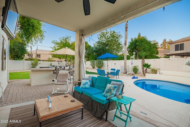 view of pool with outdoor dry bar, ceiling fan, a fenced backyard, a fenced in pool, and a patio