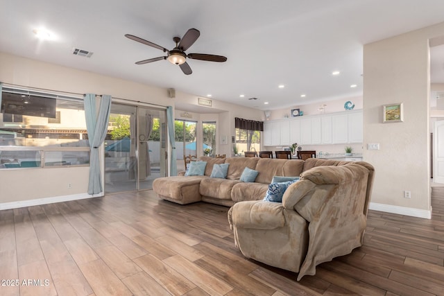 living room with ceiling fan, french doors, baseboards, wood finished floors, and visible vents