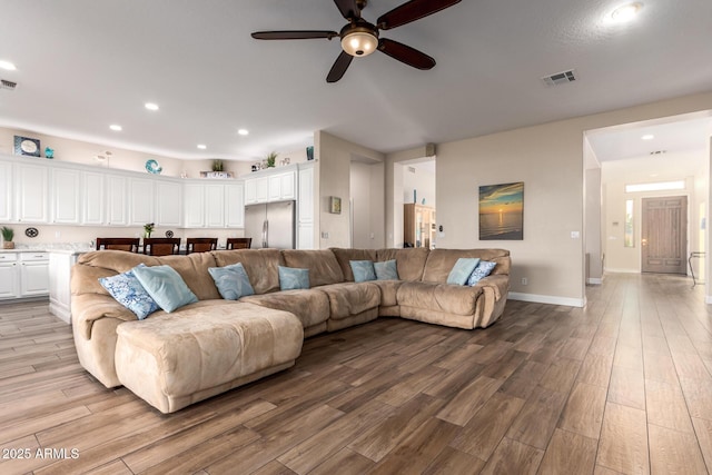 living room with visible vents, recessed lighting, light wood finished floors, and ceiling fan