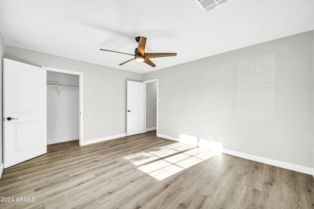 unfurnished bedroom featuring light wood-type flooring, a closet, and ceiling fan