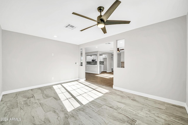 unfurnished living room with ceiling fan