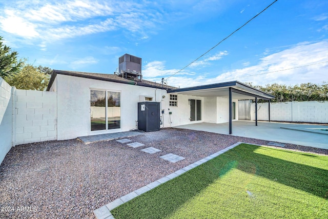 rear view of property featuring central AC unit and a patio