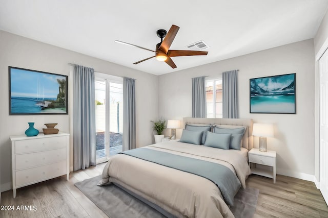 bedroom with ceiling fan, light hardwood / wood-style floors, and access to outside