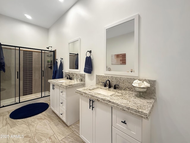 bathroom with tasteful backsplash, vanity, and an enclosed shower