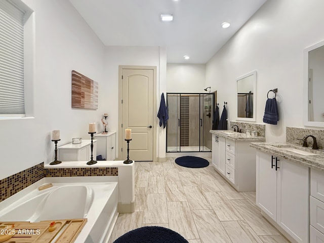 bathroom with shower with separate bathtub and vanity