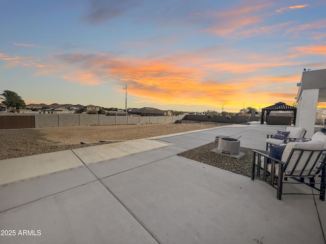 patio terrace at dusk featuring an outdoor living space and a gazebo