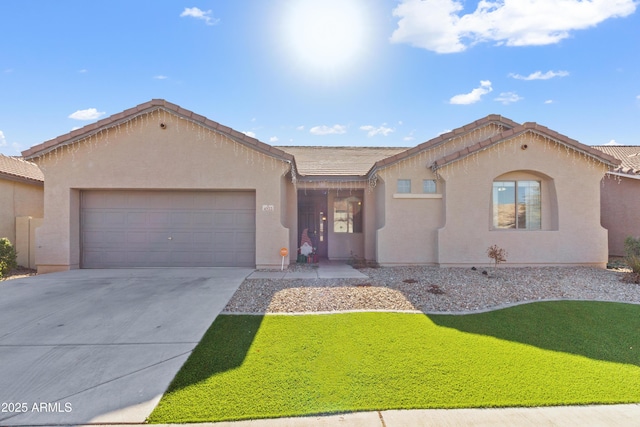 view of front of property with a front yard and a garage