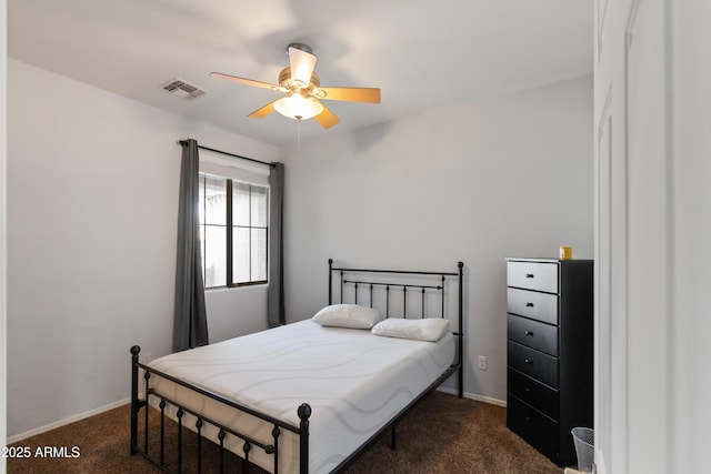 bedroom with ceiling fan and dark carpet