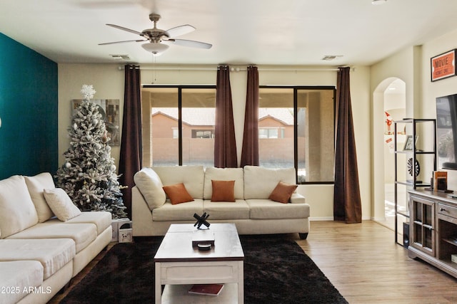 living room featuring ceiling fan and hardwood / wood-style floors