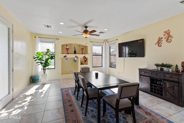 dining space with ceiling fan, plenty of natural light, and light tile patterned floors