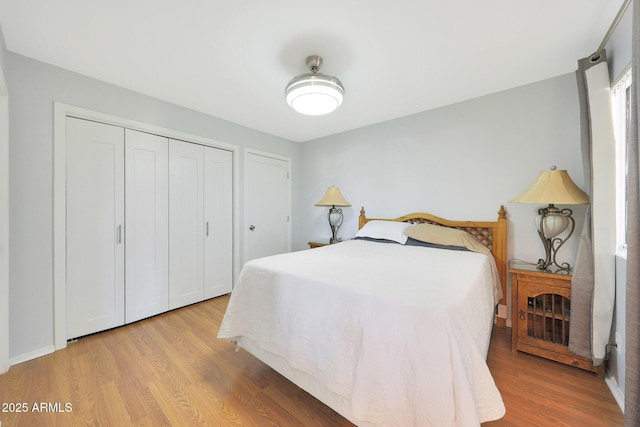 bedroom with a closet and light wood-type flooring