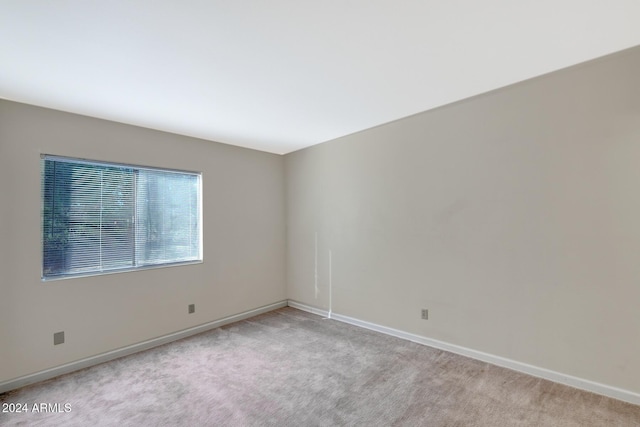 unfurnished room with light colored carpet