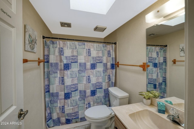 bathroom featuring toilet, a shower with curtain, vanity, and a skylight