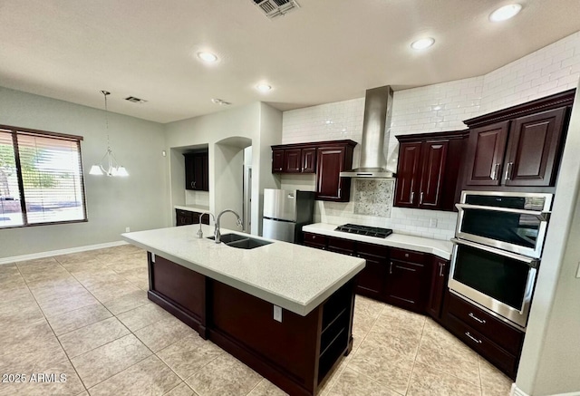 702 E Capricorn Way, Chandler, AZ 85249 - kitchen featuring stainless steel appliances, wall chimney range hood, light countertops, a sink, and tasteful backsplash