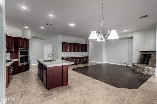 702 E Capricorn Way, Chandler, AZ 85249 - kitchen with a sink, double oven, light tile patterned floors, light countertops, and open floor plan