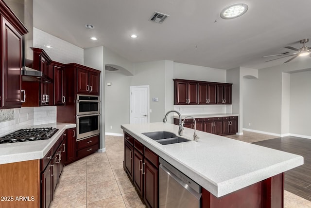 702 E Capricorn Way, Chandler, AZ 85249 - kitchen with a sink, appliances with stainless steel finishes, reddish brown cabinets, light countertops, and baseboards