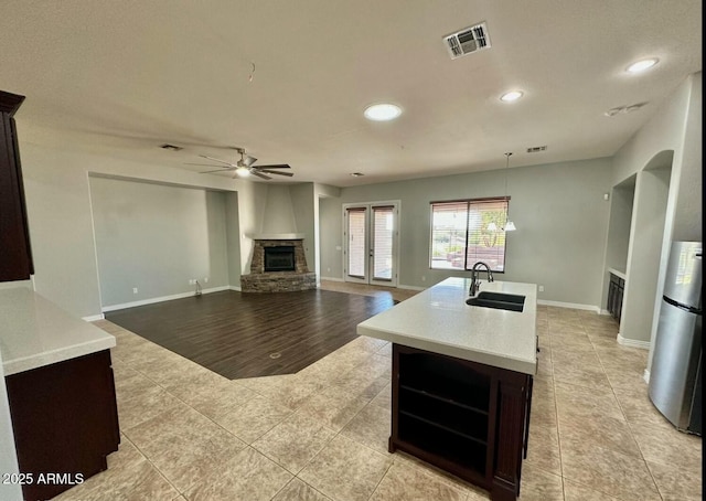 702 E Capricorn Way, Chandler, AZ 85249 - kitchen featuring a fireplace, a sink, ceiling fan, light tile patterned flooring, and recessed lighting